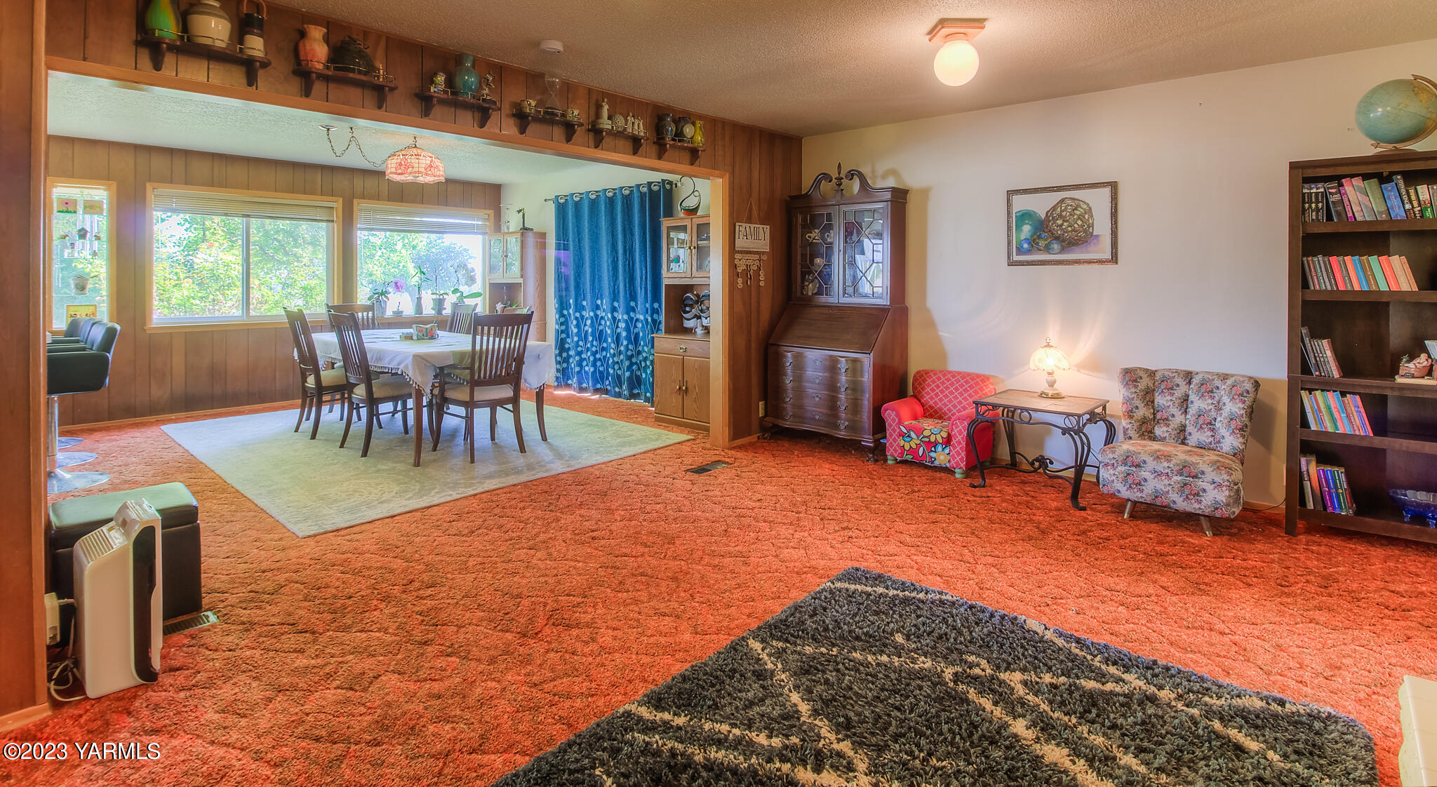 15451 Summitview Road Cowiche, WA 98923 - Photo 13 of 22 a living room with furniture a dining table and a bookshelf next to a window