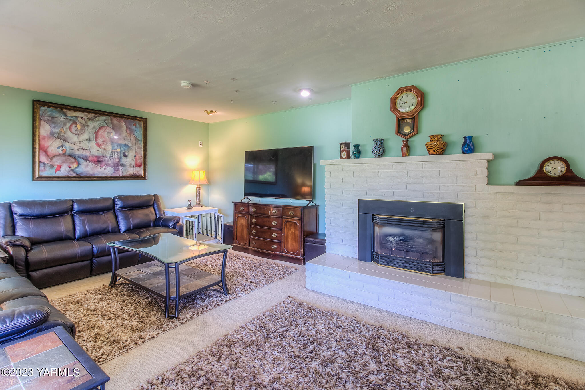 15451 Summitview Road Cowiche, WA 98923 - Photo 2 of 22 a living room with furniture a fireplace and a flat screen tv