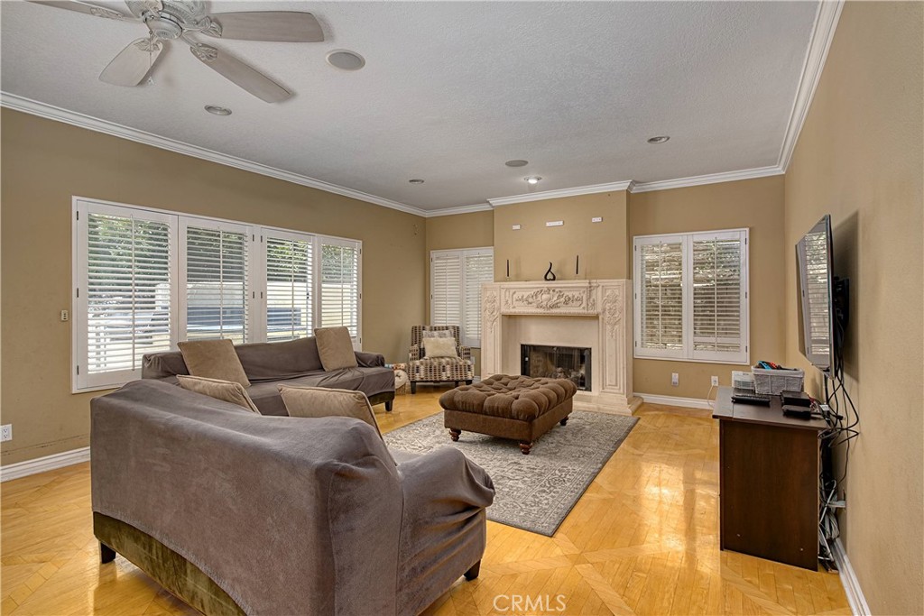23924 Clarington Drive West Hills, CA 91304 - Photo 12 of 40 a living room with furniture large window and a fireplace