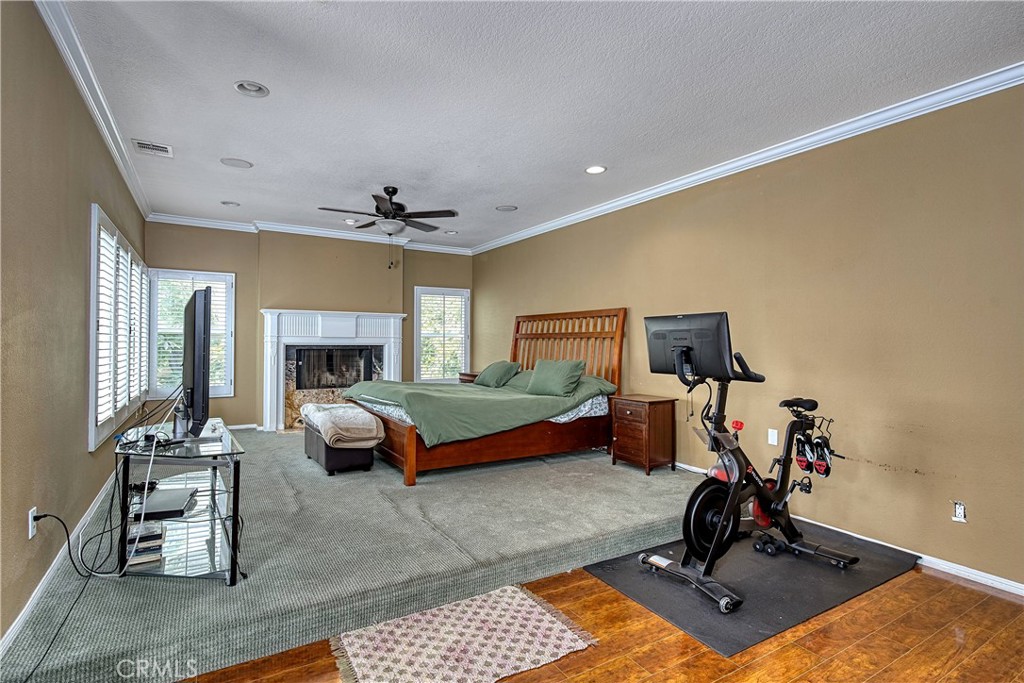 23924 Clarington Drive West Hills, CA 91304 - Photo 17 of 40 a bedroom with furniture and a fireplace