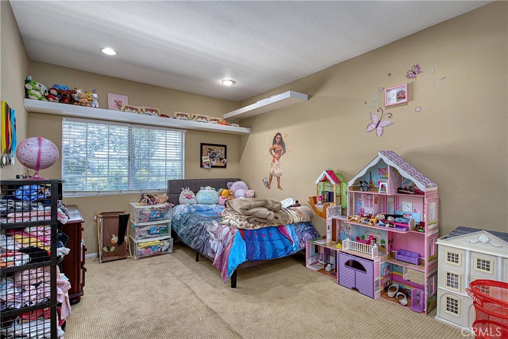 23924 Clarington Drive West Hills, CA 91304 - Photo 23 of 40 a bedroom with furniture a rug and a window