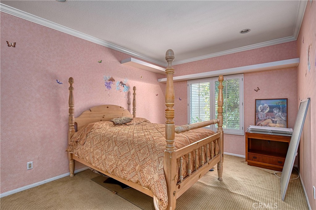 23924 Clarington Drive West Hills, CA 91304 - Photo 25 of 40 a bedroom with a bed and a chandelier