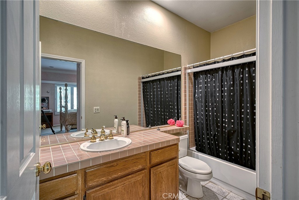 23924 Clarington Drive West Hills, CA 91304 - Photo 26 of 40 a bathroom with a sink a toilet and shower