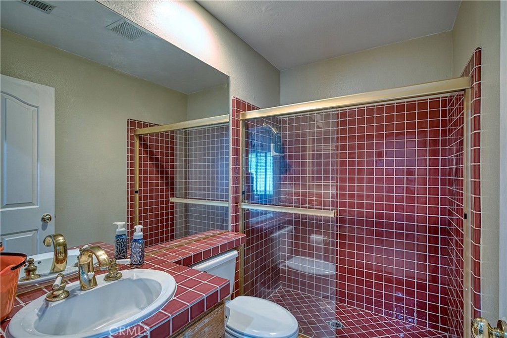 23924 Clarington Drive West Hills, CA 91304 - Photo 29 of 40 a bathroom with a sink toilet and shower