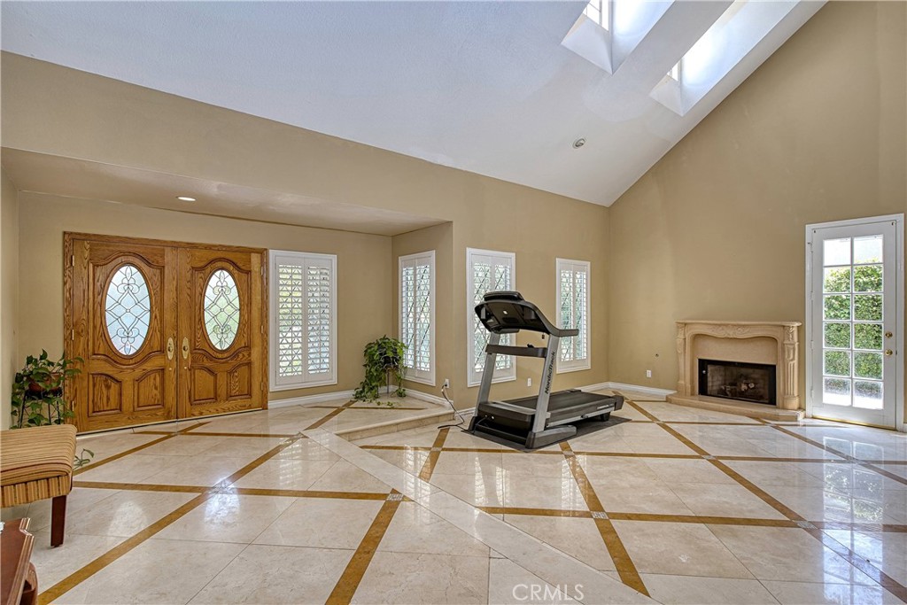 23924 Clarington Drive West Hills, CA 91304 - Photo 3 of 40 a living room with a furniture a fireplace and a large window
