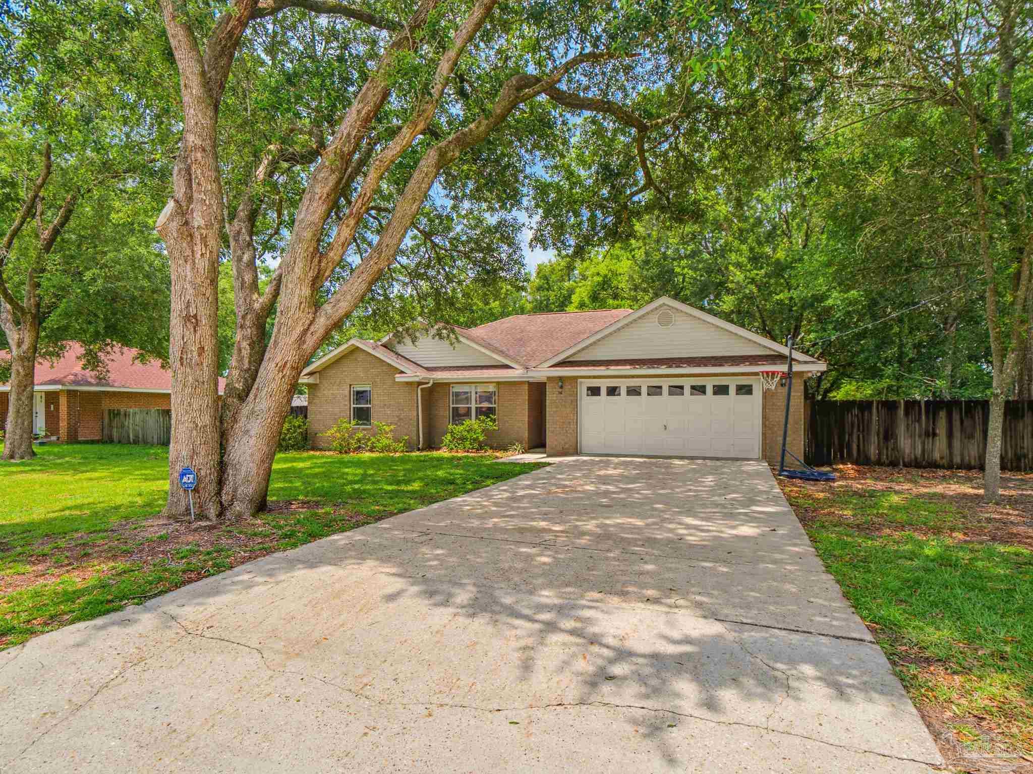 5567 Jones Street Milton, FL 32570 - Photo 2 of 48 a house with trees in front of it