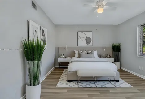 a living room with furniture and a potted plant