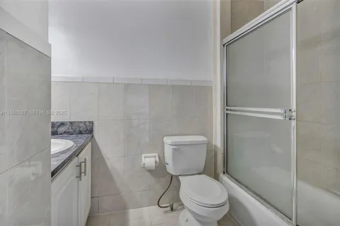 a white toilet sitting next to a bathroom sink