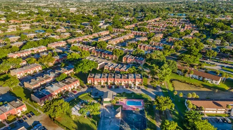 an aerial view of residential houses with outdoor space