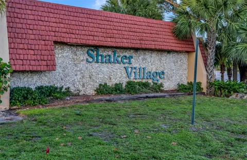 a view of a backyard with plants and large tree