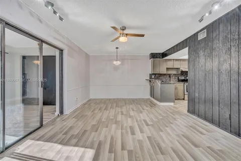 a view of a kitchen with a sink and refrigerator