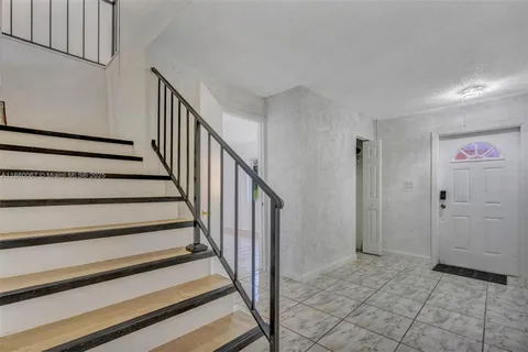 a view of a hallway with wooden floor and entryway