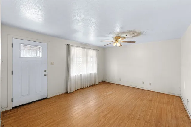 wooden floor in an empty room with a window