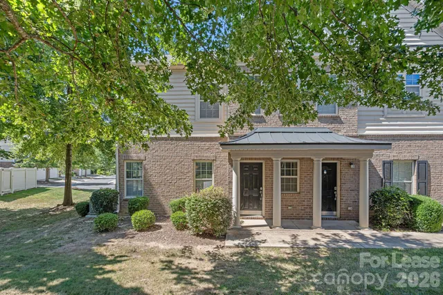 front view of a house with a tree