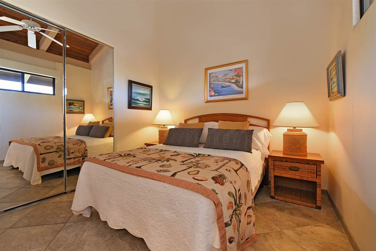 3543 Lower Honoapiilani Road, Unit B405 Lahaina, HI 96761 - Photo 24 of 30 a bedroom with a bed and wooden floor
