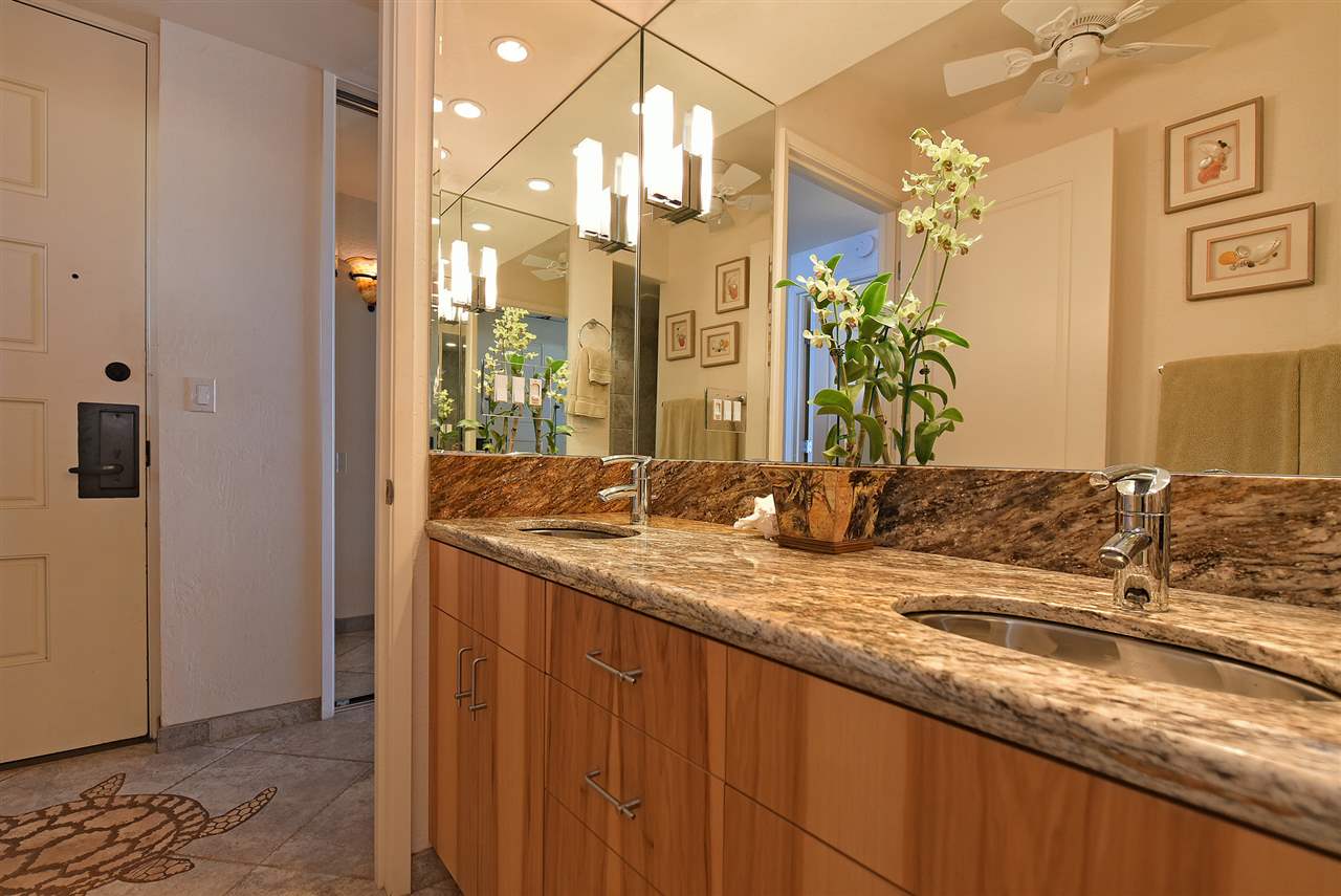 3543 Lower Honoapiilani Road, Unit B405 Lahaina, HI 96761 - Photo 27 of 30 a bathroom with a granite countertop sink and a mirror