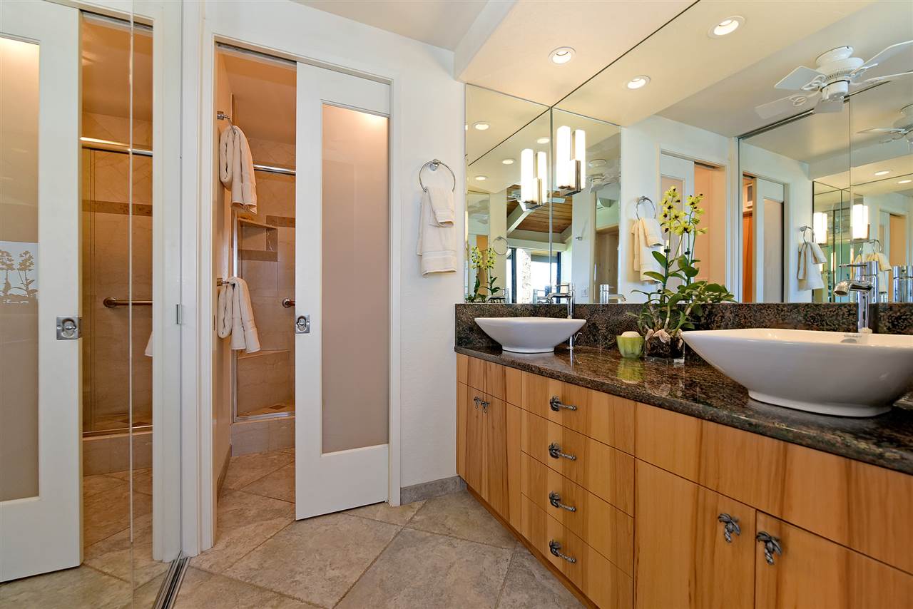 3543 Lower Honoapiilani Road, Unit B405 Lahaina, HI 96761 - Photo 29 of 30 a spacious bathroom with a double vanity sink a large mirror and a shower