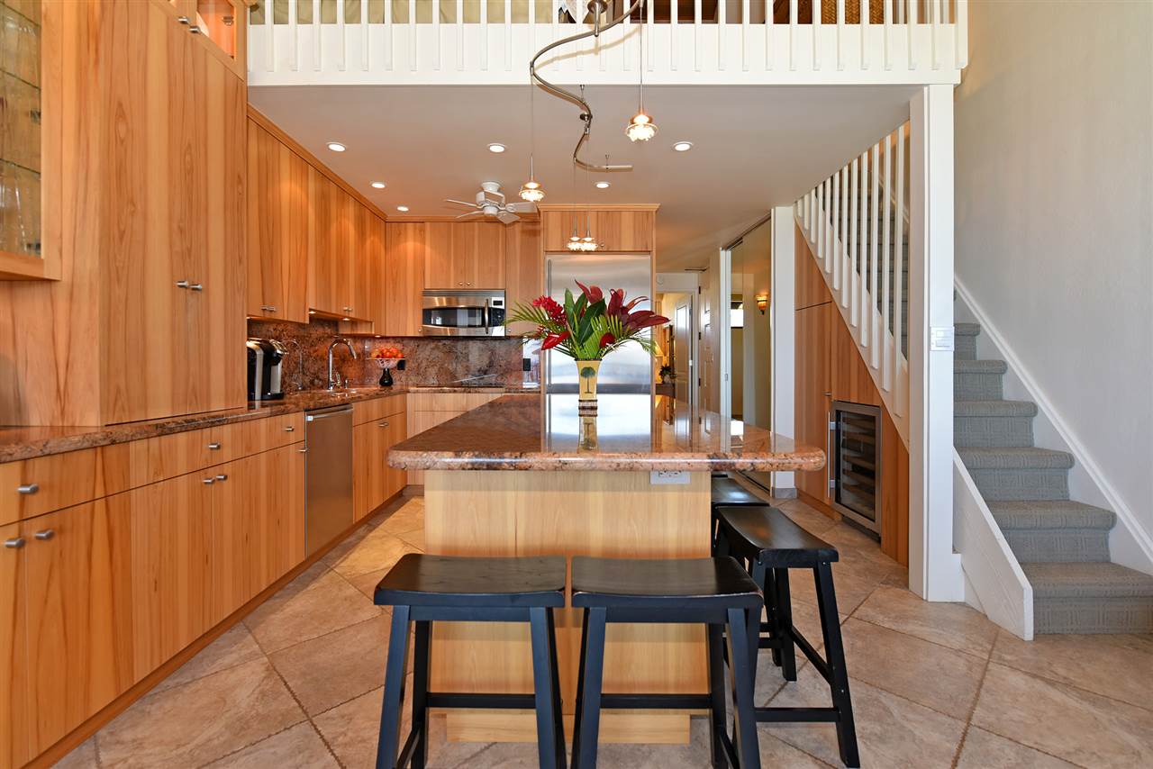 3543 Lower Honoapiilani Road, Unit B405 Lahaina, HI 96761 - Photo 4 of 30 a view of a dining hall with a dining table chairs and couches with wooden floor