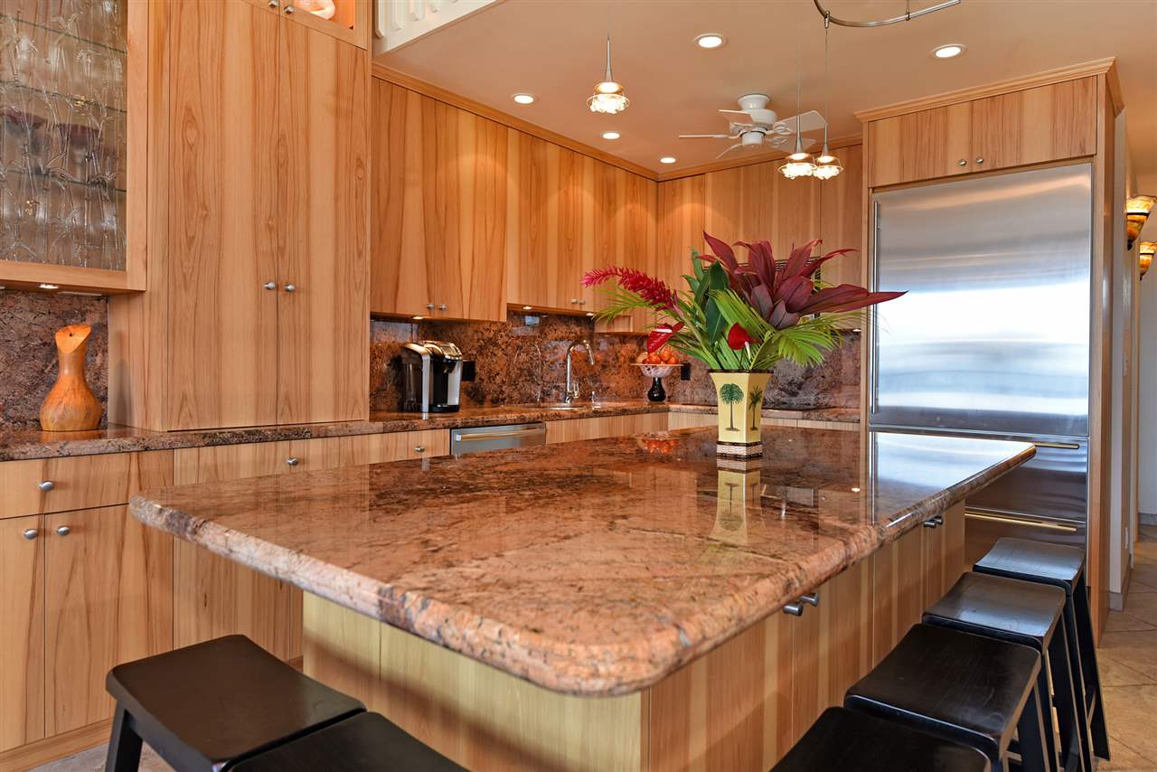 3543 Lower Honoapiilani Road, Unit B405 Lahaina, HI 96761 - Photo 6 of 30 a kitchen with kitchen island a sink and a refrigerator