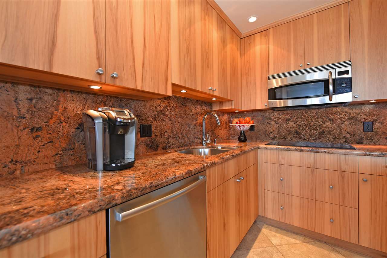 3543 Lower Honoapiilani Road, Unit B405 Lahaina, HI 96761 - Photo 8 of 30 a kitchen with stainless steel appliances granite countertop a sink and a microwave
