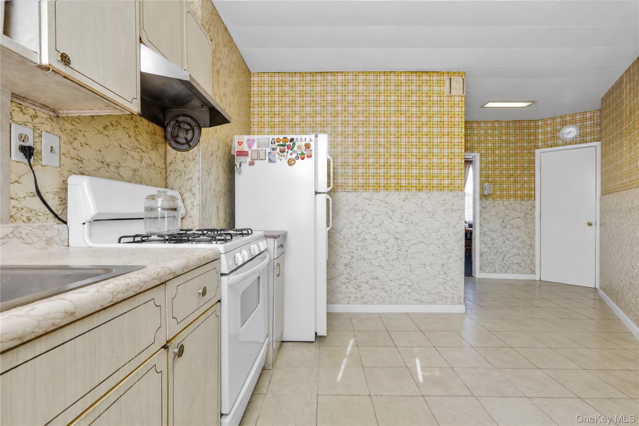 42-01 Newtown Road Queens, NY 11103 - Photo 12 of 27 a kitchen with a sink cabinets and a refrigerator
