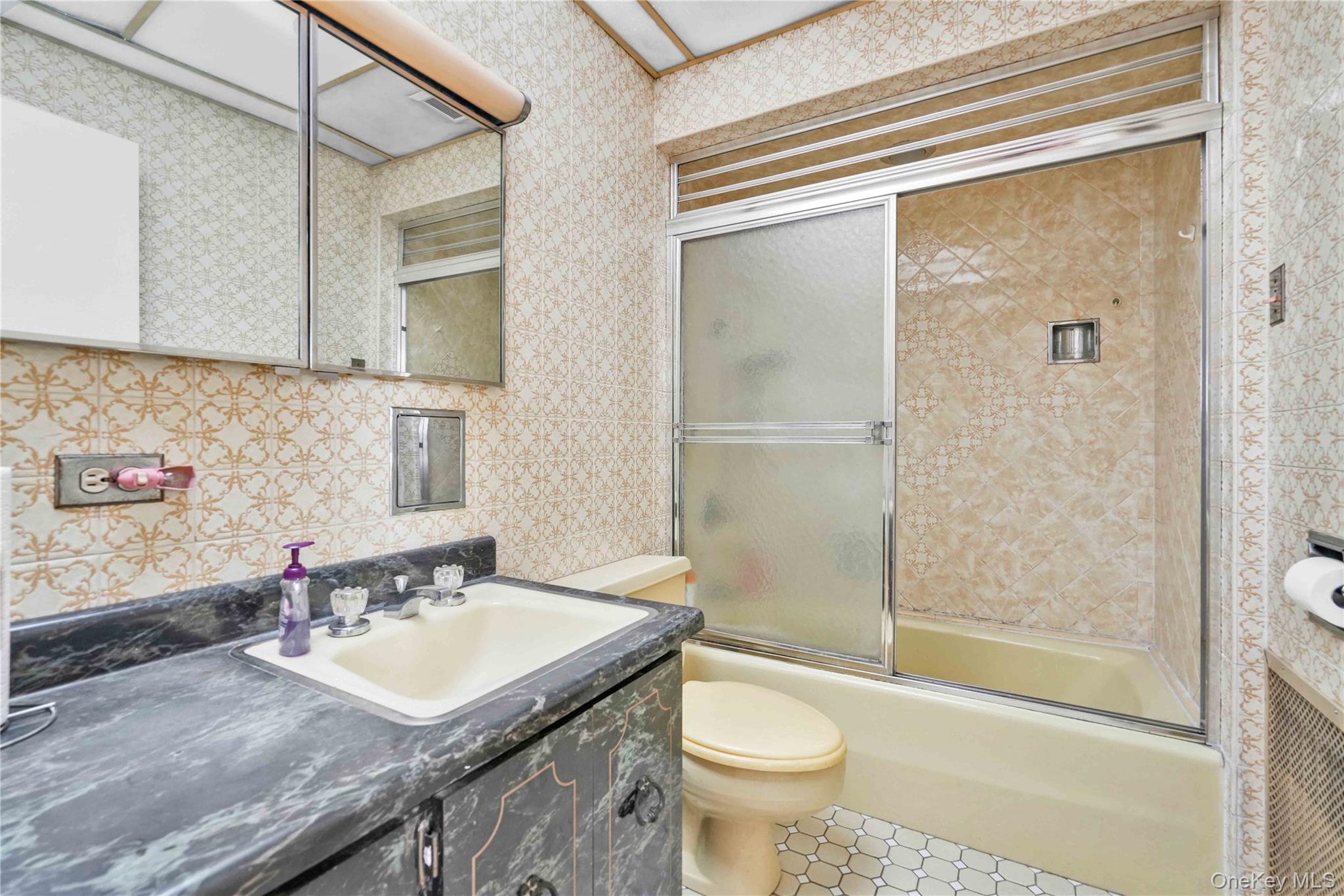 42-01 Newtown Road Queens, NY 11103 - Photo 13 of 27 a bathroom with a sink toilet and shower