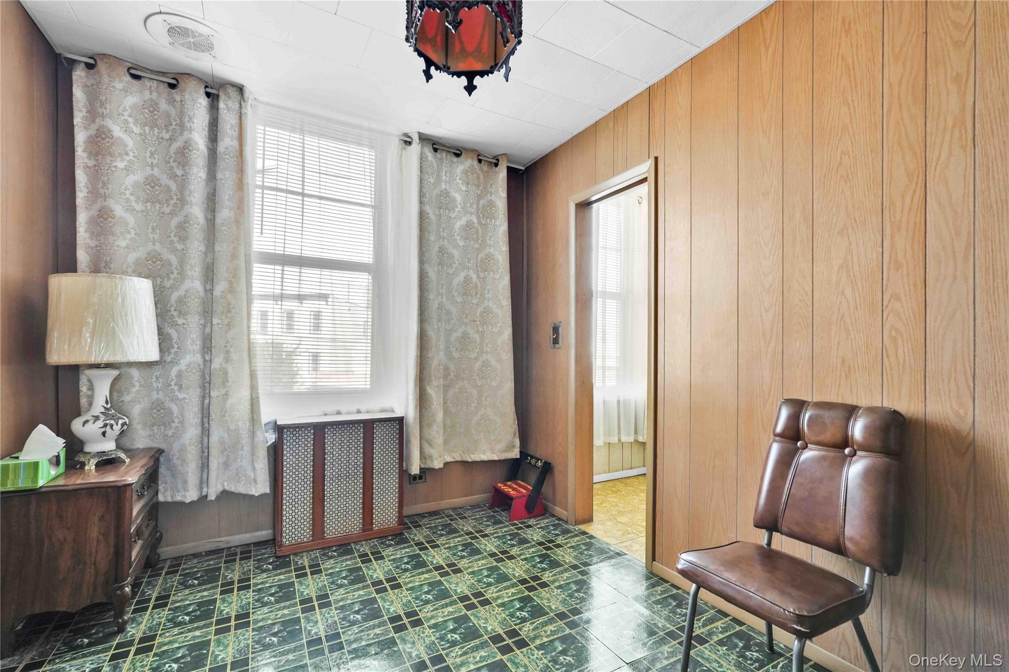 42-01 Newtown Road Queens, NY 11103 - Photo 19 of 27 a living room with furniture and a window