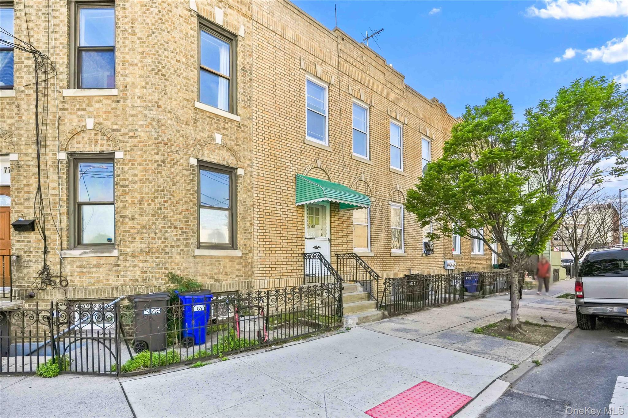 42-01 Newtown Road Queens, NY 11103 - Photo 3 of 27 a front view of a building with a garden
