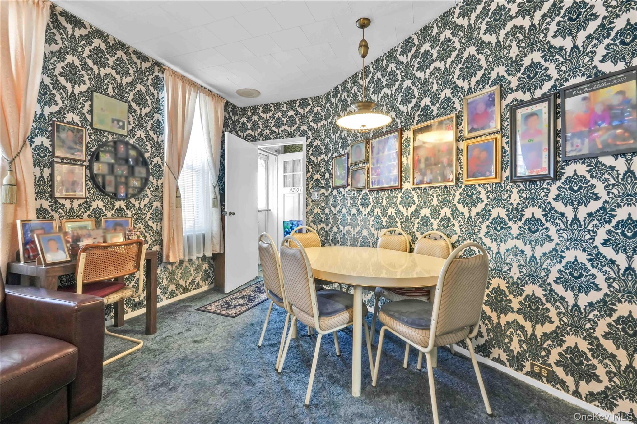 42-01 Newtown Road Queens, NY 11103 - Photo 7 of 27 a view of a dining room with furniture and chandelier
