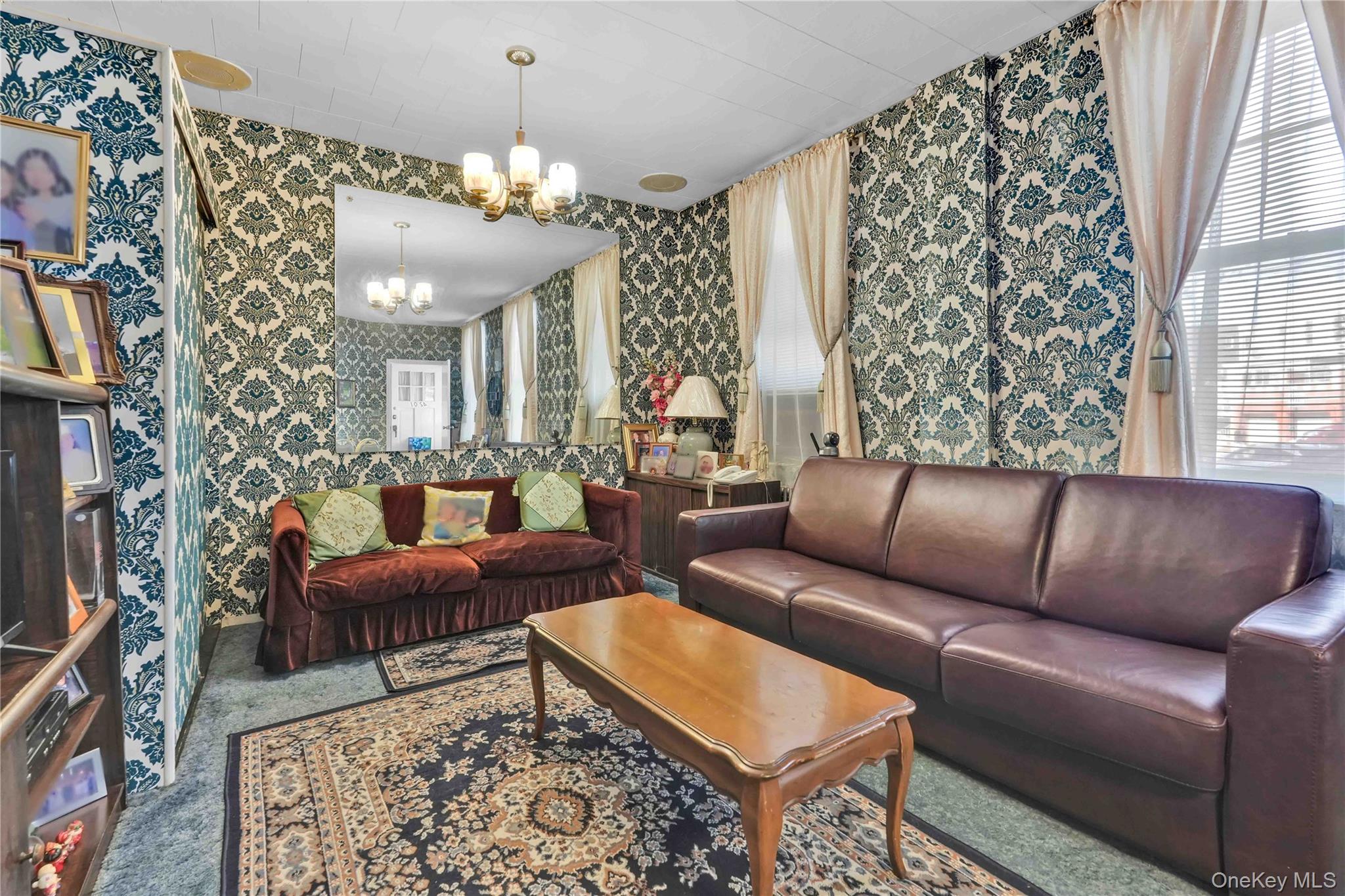 42-01 Newtown Road Queens, NY 11103 - Photo 8 of 27 a living room with furniture and a chandelier