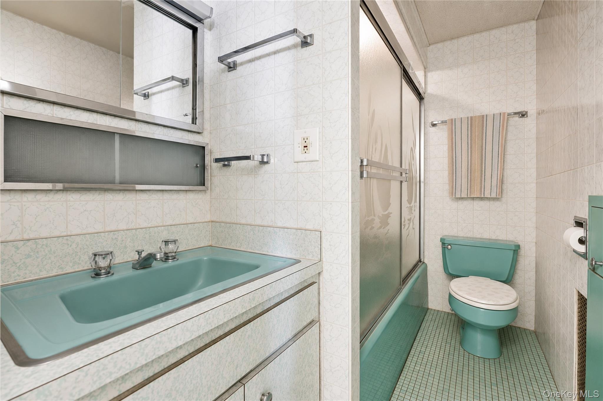 42-01 Newtown Road Queens, NY 11103 - Photo 9 of 27 a bathroom with a sink a toilet and shower