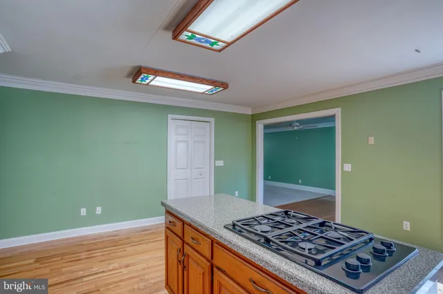 a room with a stove and a wooden floor