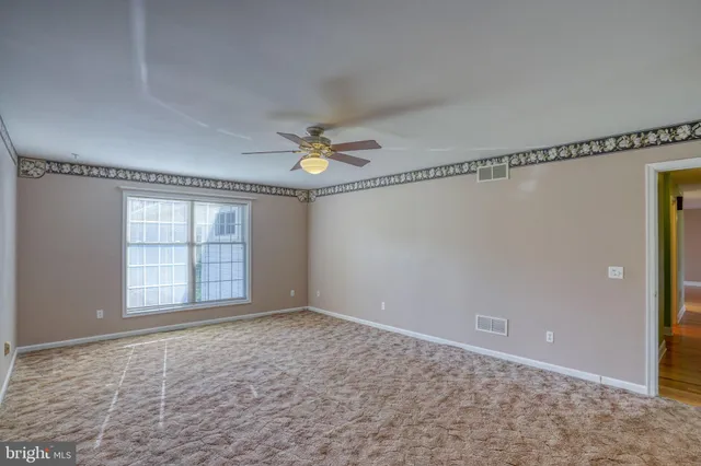 a view of an empty room with a window