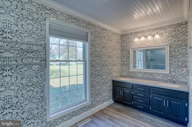 a bathroom with a sink a mirror and shower