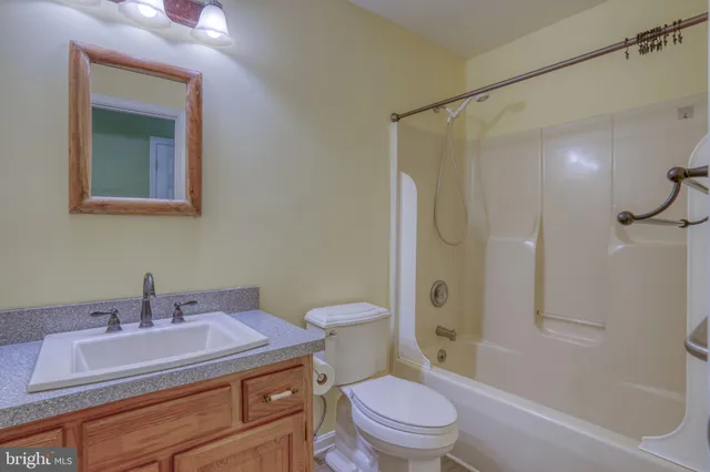 a bathroom with a sink toilet vanity and shower