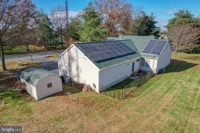 a aerial view of a house with a yard and sitting area