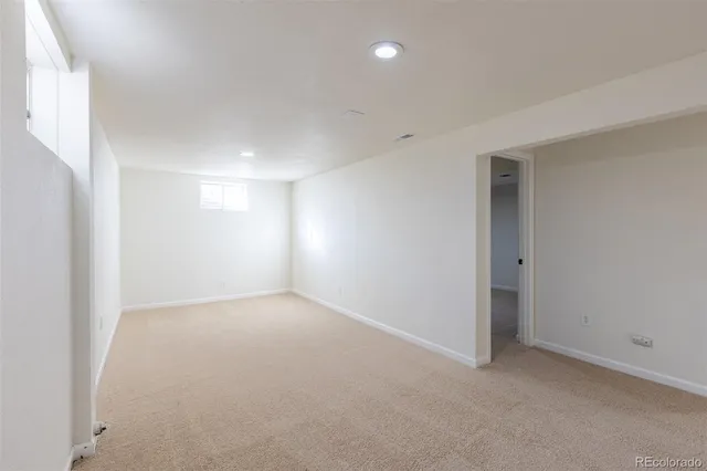 an empty room with a empty space and windows