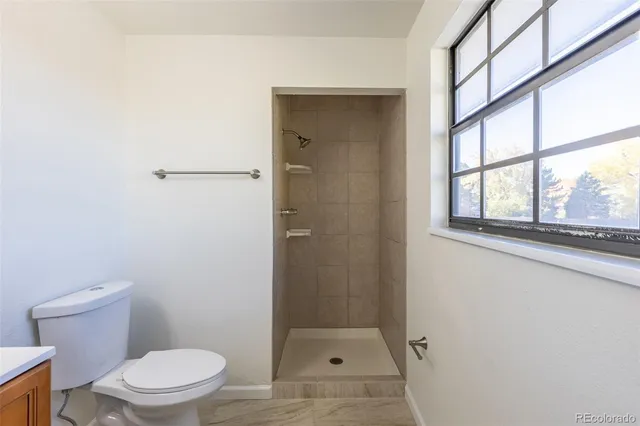 a bathroom with a toilet and a shower