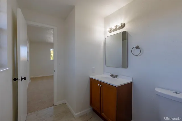 a bathroom with a sink vanity and a mirror
