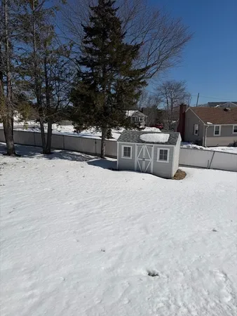 a view of a yard with snow on the road
