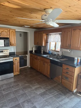 a kitchen with stainless steel appliances a sink stove and cabinets