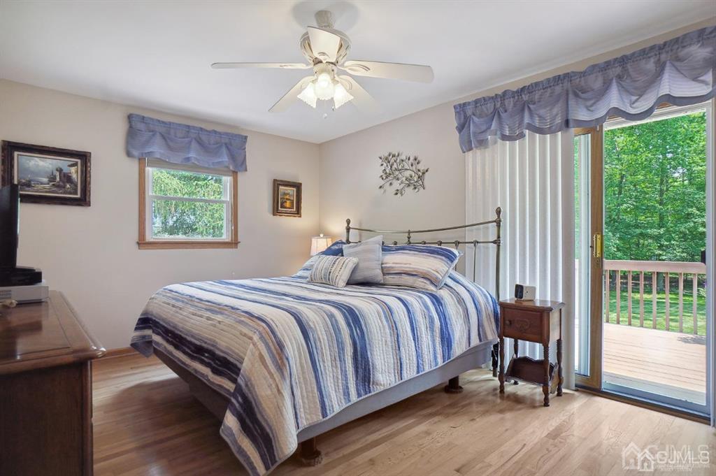 8 Tamarack Road Edison, NJ 08820 - Photo 13 of 31 a bedroom with a large bed and a chandelier