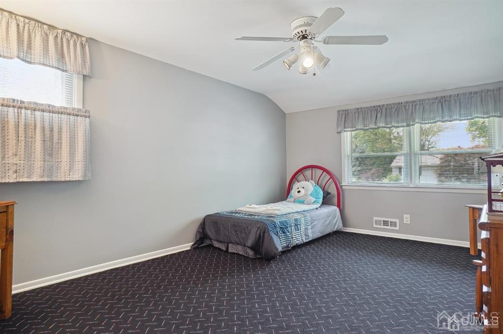 8 Tamarack Road Edison, NJ 08820 - Photo 19 of 31 a living room with a bed furniture and a window