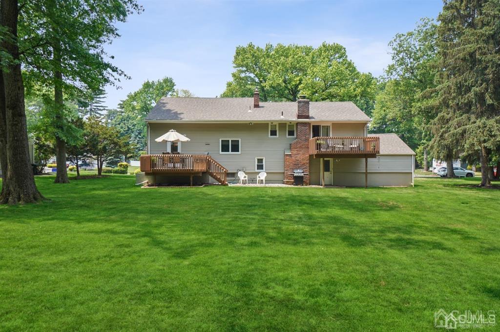 8 Tamarack Road Edison, NJ 08820 - Photo 27 of 31 a front view of a house with a garden and trees