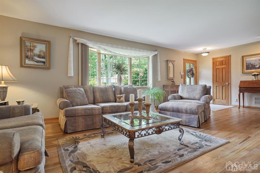 8 Tamarack Road Edison, NJ 08820 - Photo 3 of 31 a living room with furniture a rug and a large window