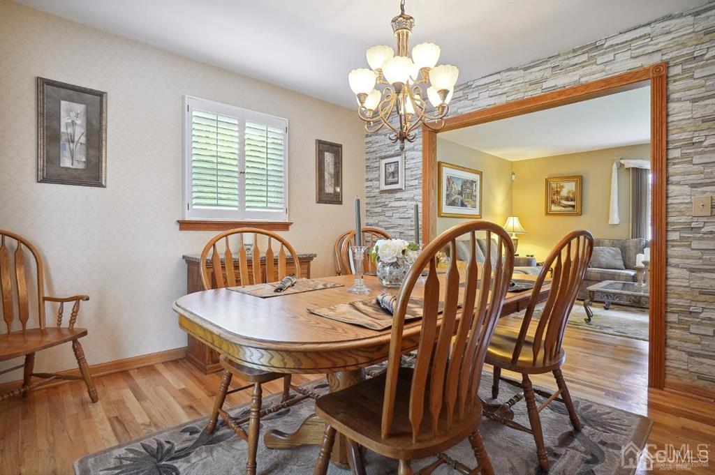 8 Tamarack Road Edison, NJ 08820 - Photo 5 of 31 a view of a dining room with furniture a chandelier and wooden floor