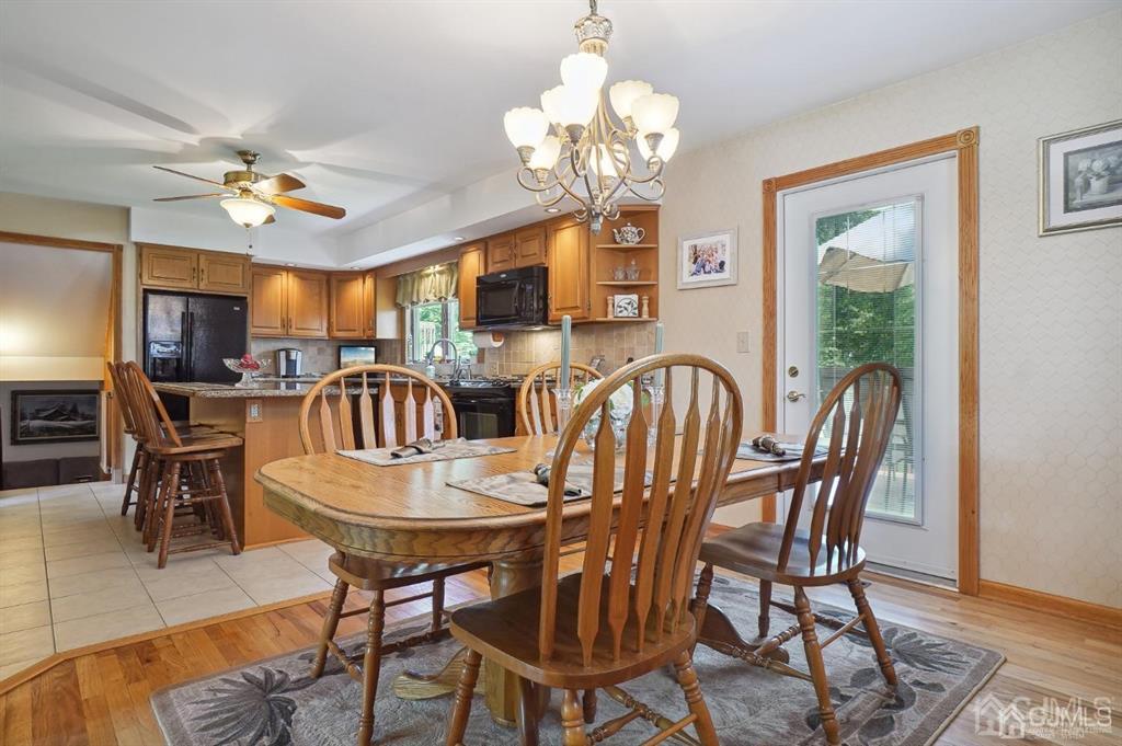 8 Tamarack Road Edison, NJ 08820 - Photo 6 of 31 a view of a dining room with furniture a chandelier and wooden floor