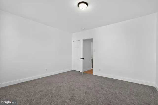 a view of a pathway of a building with wooden fence