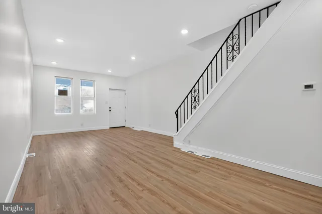 a view of an entryway with wooden floor