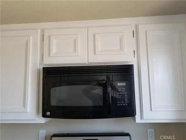 a stove top oven sitting inside of a kitchen